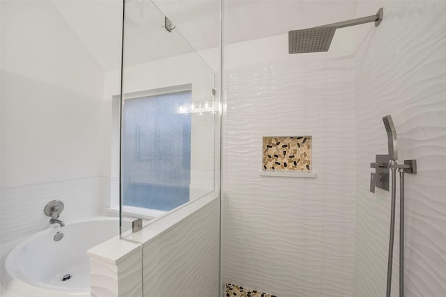 full bath featuring a garden tub, vaulted ceiling, and a tile shower