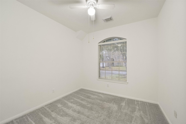 carpeted spare room with visible vents, a ceiling fan, and baseboards