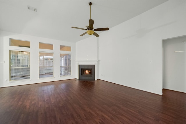 unfurnished living room with visible vents, a ceiling fan, a tile fireplace, wood finished floors, and high vaulted ceiling