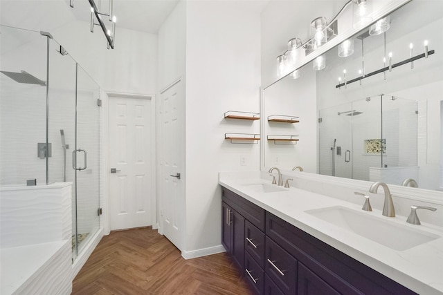 bathroom featuring baseboards, double vanity, a sink, and a shower stall