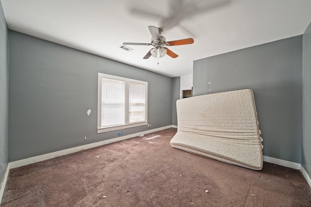 living area featuring carpet floors, baseboards, visible vents, and ceiling fan