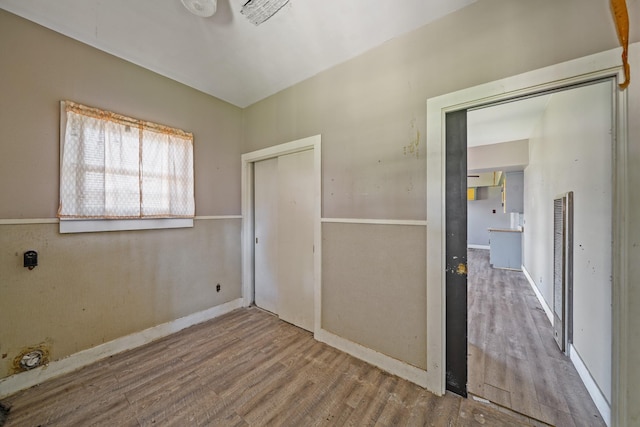 unfurnished bedroom featuring a closet and wood finished floors