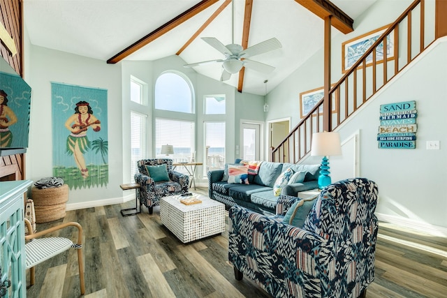 living area with wood finished floors, high vaulted ceiling, beamed ceiling, baseboards, and stairs