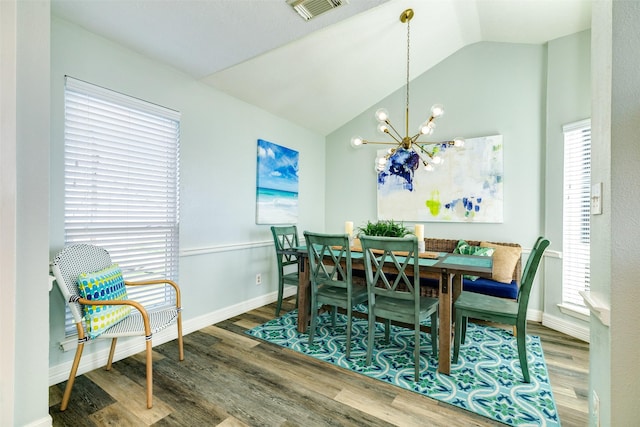 dining area featuring baseboards, visible vents, lofted ceiling, wood finished floors, and a notable chandelier