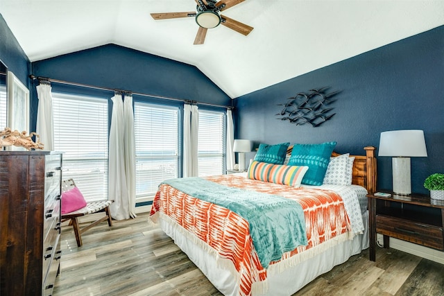 bedroom featuring lofted ceiling, a ceiling fan, and wood finished floors