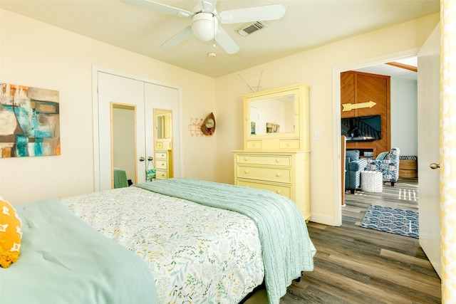 bedroom with visible vents, dark wood finished floors, and a ceiling fan