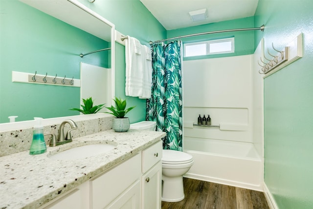 bathroom with shower / bath combo with shower curtain, vanity, toilet, and wood finished floors