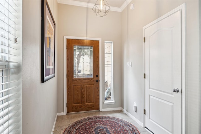 entryway with baseboards and crown molding