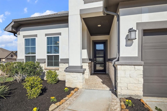 doorway to property featuring stone siding and stucco siding