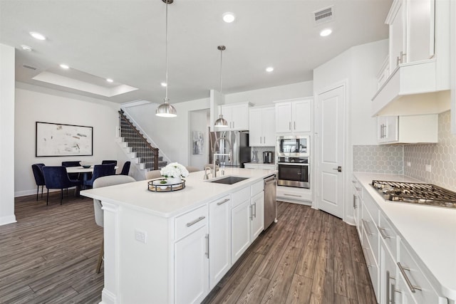 kitchen with stainless steel appliances, recessed lighting, a sink, and dark wood-style floors