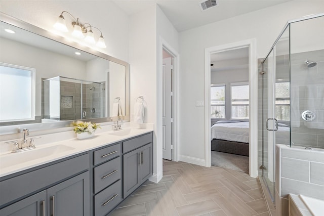 ensuite bathroom featuring a stall shower, visible vents, a sink, and double vanity