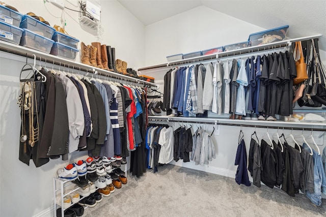 spacious closet featuring vaulted ceiling and carpet floors