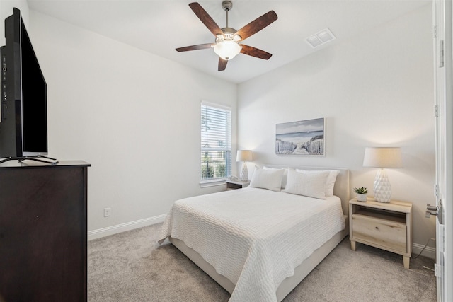 bedroom with light carpet, a ceiling fan, visible vents, and baseboards