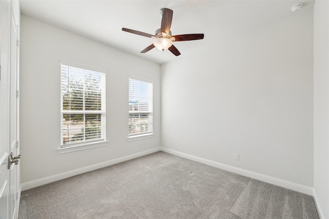 empty room featuring carpet floors, ceiling fan, and baseboards