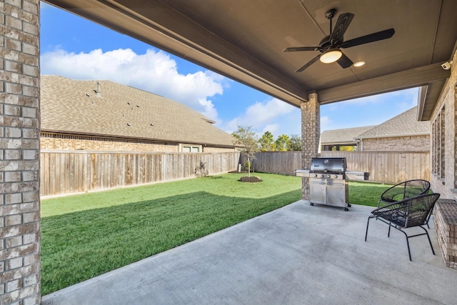 view of patio with ceiling fan, a grill, and a fenced backyard