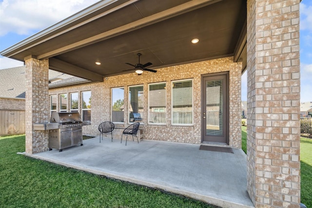 view of patio / terrace with fence, a ceiling fan, and a grill