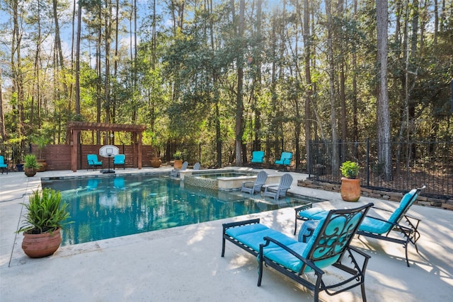 view of swimming pool featuring a patio area, fence private yard, a pool with connected hot tub, and a pergola