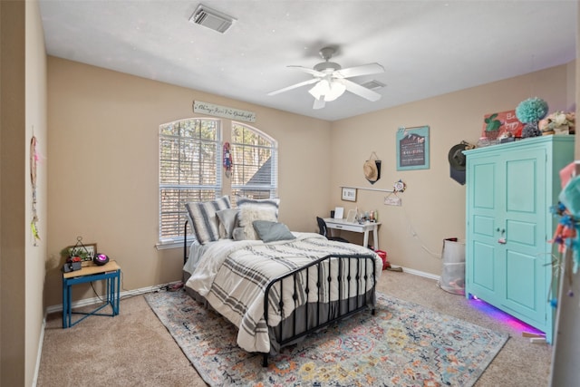 carpeted bedroom featuring ceiling fan, visible vents, and baseboards