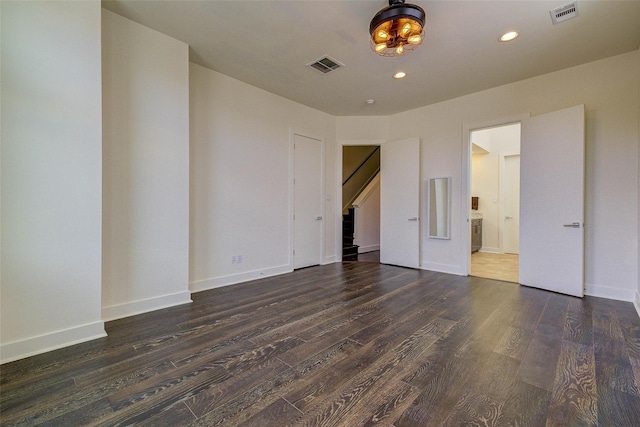 unfurnished bedroom with recessed lighting, visible vents, baseboards, and wood finished floors