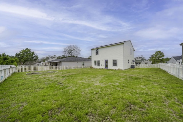 back of property featuring a yard, cooling unit, and a fenced backyard