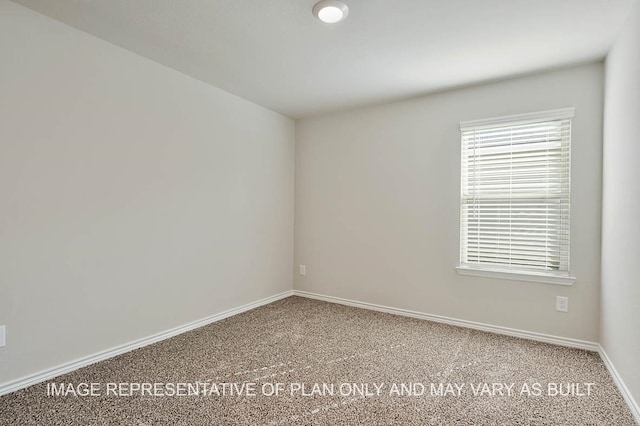 carpeted empty room with baseboards