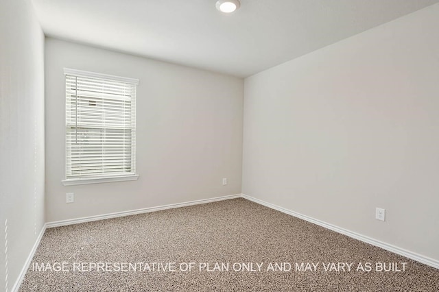 carpeted spare room with baseboards