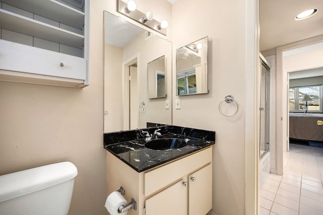 bathroom featuring toilet, tile patterned floors, a shower with shower door, vanity, and recessed lighting