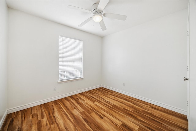 spare room with ceiling fan, baseboards, and wood finished floors