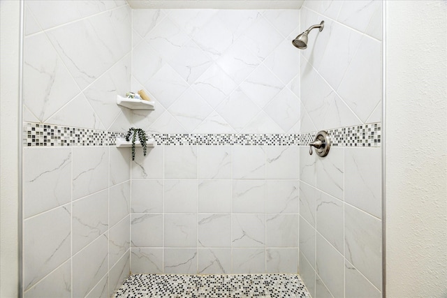 bathroom with a tile shower