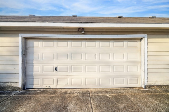 garage featuring concrete driveway