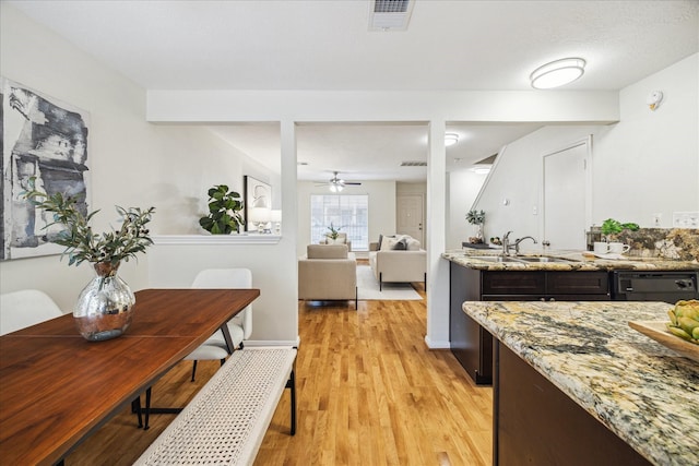 dining space featuring light wood-type flooring, baseboards, visible vents, and ceiling fan