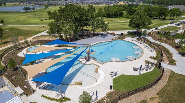 9975 Monarch Landing Cv, Willis, TX 77318 - bird's eye view of a pool, a nearby body of water, and a local golf course