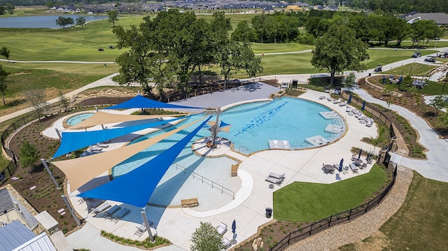 9975 Monarch Landing Cv, Willis, TX 77318 - bird's eye view of a pool area and a nearby body of water