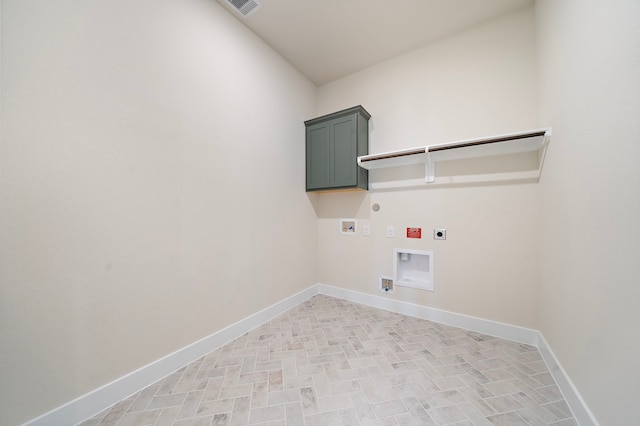9975 Monarch Landing Cv, Willis, TX 77318 - laundry area with hookup for an electric dryer, gas dryer hookup, washer hookup, cabinet space, and baseboards