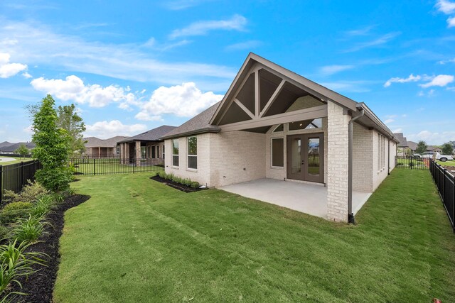9975 Monarch Landing Cv, Willis, TX 77318 - back of property with brick siding and a patio
