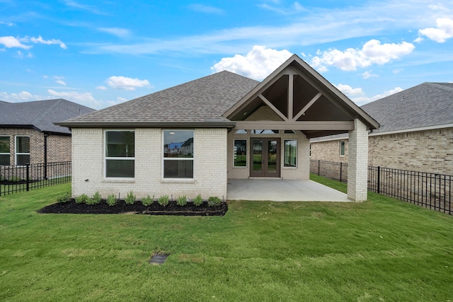9975 Monarch Landing Cv, Willis, TX 77318 - back of property featuring brick siding, a patio, french doors, and roof with shingles