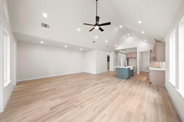 9975 Monarch Landing Cv, Willis, TX 77318 - unfurnished living room with a ceiling fan, baseboards, recessed lighting, high vaulted ceiling, and light wood-style floors