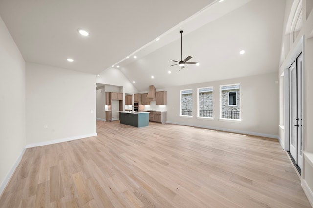 9975 Monarch Landing Cv, Willis, TX 77318 - unfurnished living room featuring ceiling fan, light wood-type flooring, baseboards, recessed lighting, and high vaulted ceiling