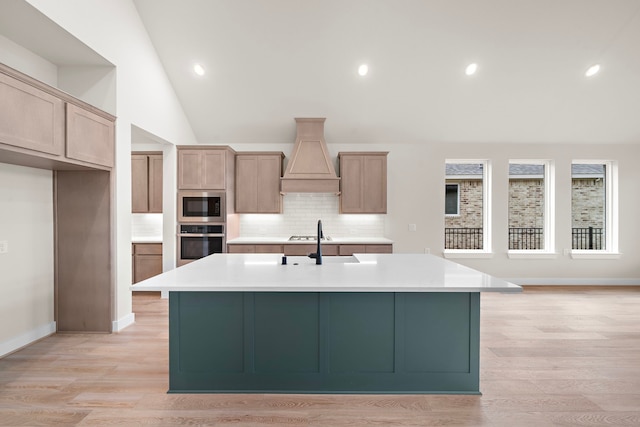 9975 Monarch Landing Cv, Willis, TX 77318 - kitchen featuring stainless steel appliances, custom range hood, lofted ceiling, decorative backsplash, and light countertops