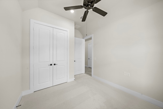 9975 Monarch Landing Cv, Willis, TX 77318 - unfurnished bedroom with vaulted ceiling, light carpet, a closet, baseboards, and a ceiling fan