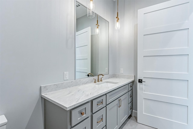 bathroom featuring vanity and toilet