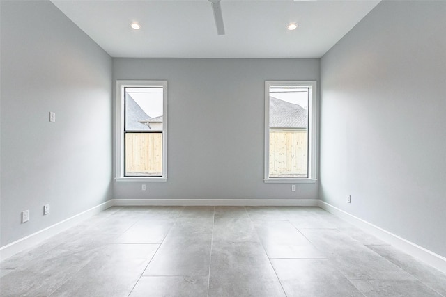 spare room with baseboards and recessed lighting