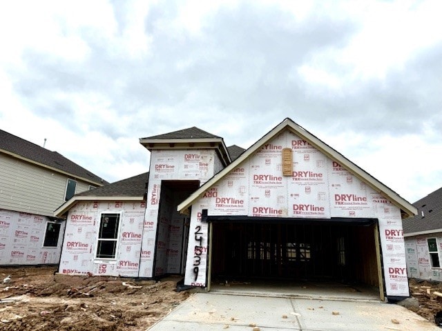 property under construction with concrete driveway and a garage