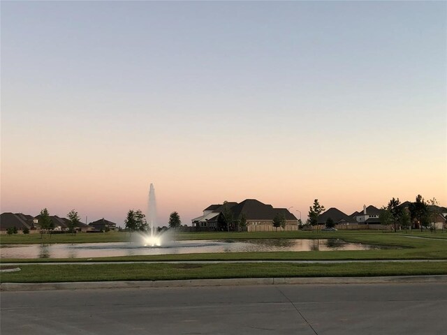 24539 Greeley Lake Dr, Katy, TX 77493 - view of street featuring sidewalks, a water view, and curbs