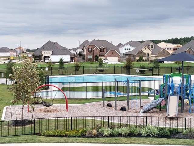 24539 Greeley Lake Dr, Katy, TX 77493 - community pool with a residential view, a yard, playground community, and fence