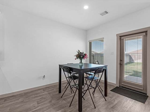 dining room with wood finished floors, visible vents, and recessed lighting