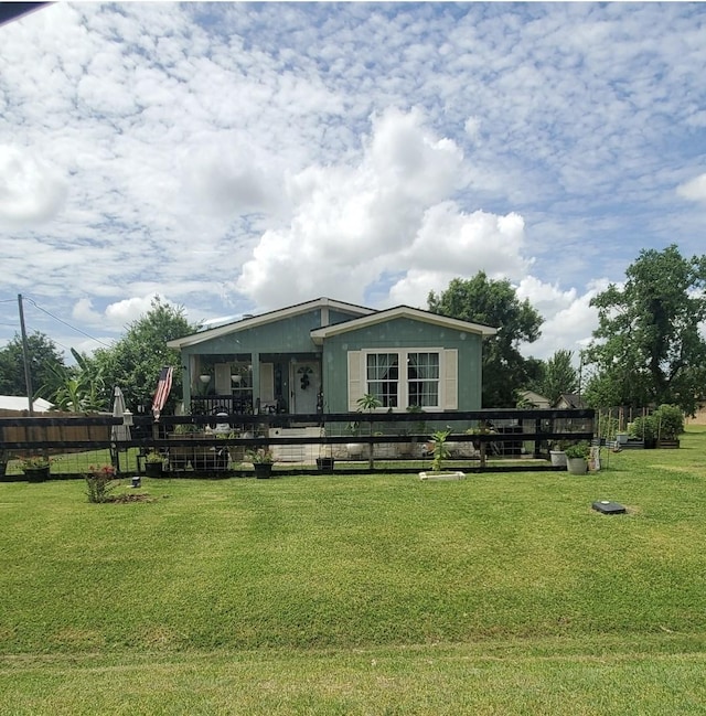 view of front of house featuring a front lawn and fence