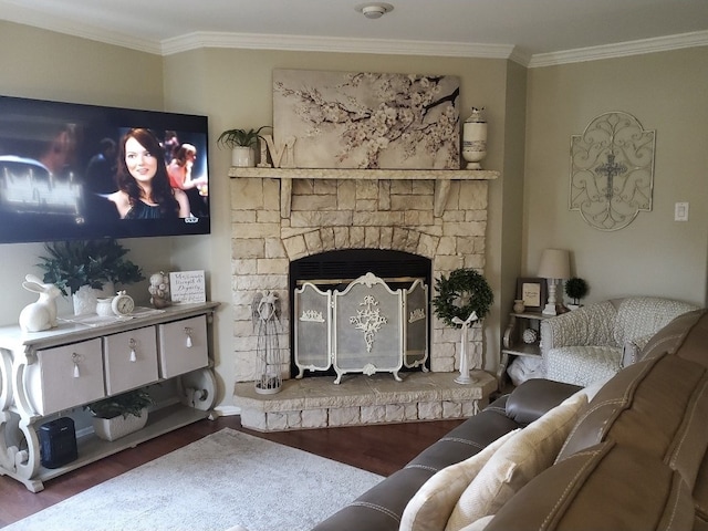 living area featuring a stone fireplace, wood finished floors, and crown molding