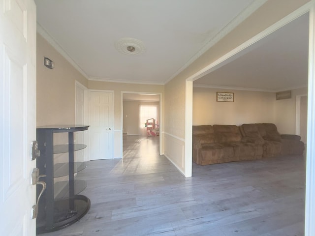 hallway with wood finished floors and ornamental molding