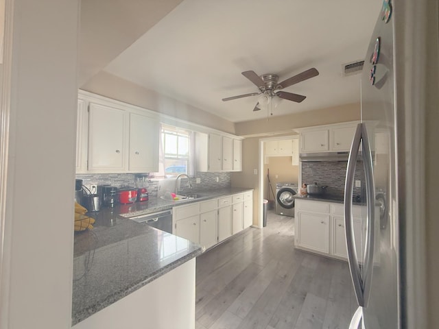 kitchen featuring visible vents, appliances with stainless steel finishes, light wood-style floors, white cabinets, and washer / clothes dryer